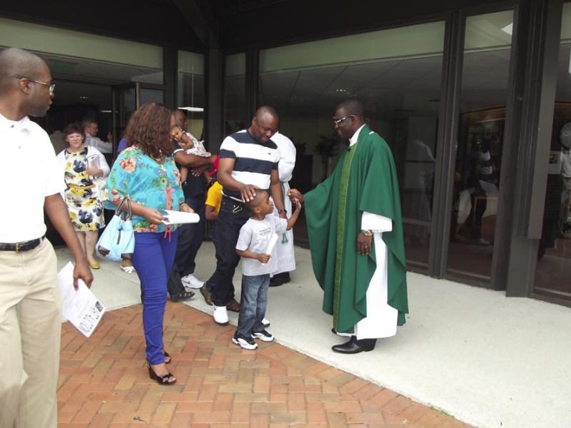 Fr. Ferdinand greets parishioners outside of WLIFC