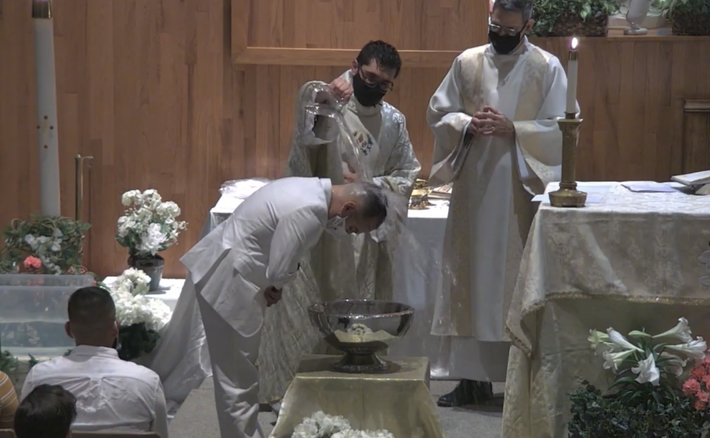 Padre Leandro baptizes during Easter Vigil 2021