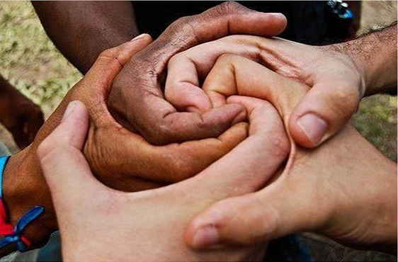 Multicultural hands joined in spiral symbolizing honest conversations about racism