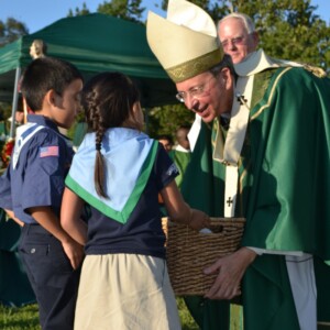 Young parishioners presenting gifts to Archbishop Lori
