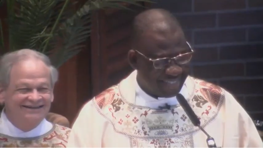 Fr. Ferdinand & Fr. Gerry smile at Fr. Ferdinand's final Mass at St. John's