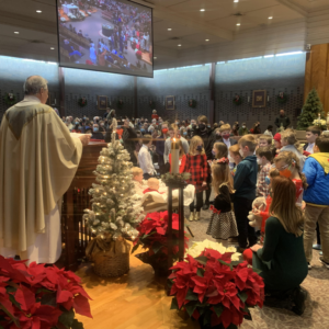 Christmas Mass with children around manger 2022