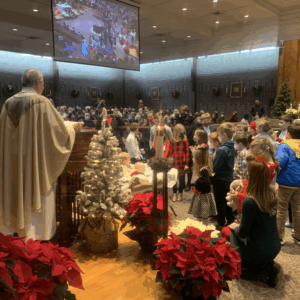 Christmas Mass with children around manger 2022